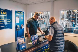 Mr Tyre Cannock paying customer at the till