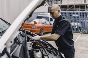 Mr Tyre mechanic inspecting engine