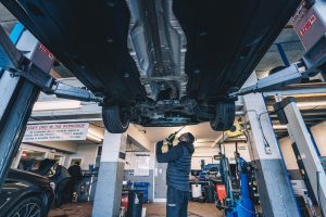 Mechanic performing service checks.