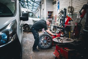 Mr Tyre Nottingham (Carlton Rd) mechanic having removed wheel for checking.