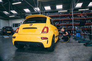 Mr Tyre technician performing tyre pressure checks on Fiat