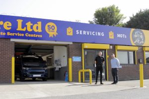 Two Mr Tyre team members stand in front of Bloxwich autocentre