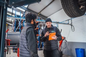 Two technicians discuss diagnostics at Mr Tyre Bloxwich