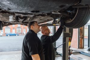Mechanics carrying out car checks.